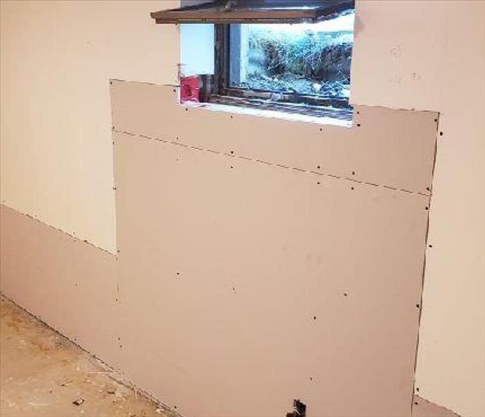 A wall with new drywall that still needs to be taped and finished
