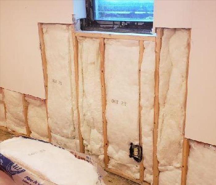 An open wall after new insulation has been placed