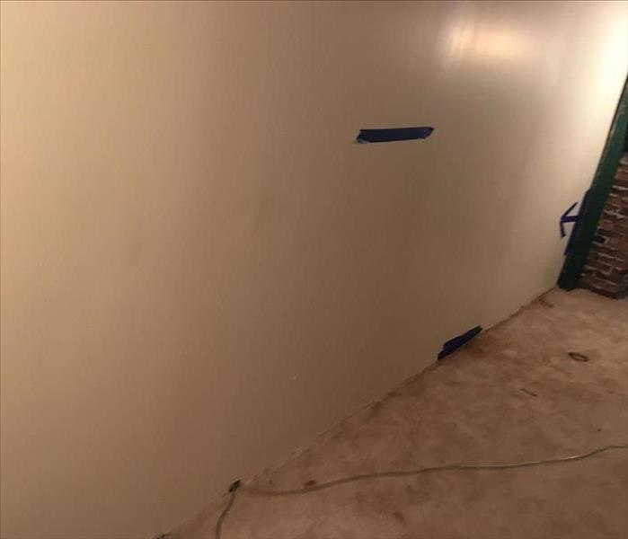 A seemingly clean wall that has water damage hidden behind it